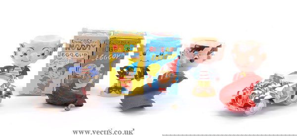 Noddy - A Group of Six Egg-cups: Noddy six egg-cups: (1) Fairylite Noddy, ceramic, Foreign, plus blue felt hat with bell; (2) Fairylite Big Ears, ceramic, Foreign; (3) Big Ears, plastic, plus hat; (4) Noddy egg cup, plastic, China, b