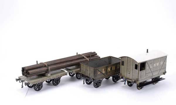 Carette/Bassett-Lowke LNWR 4-wheel Goods Wagons: Carette for Bassett-Lowke Gauge 1 LNWR 4-wheel Goods Wagons consisting of Brake Van, Open Wagon and a pair of Lumber Wagons. Condition is generally Good to Good Plus. (3)
