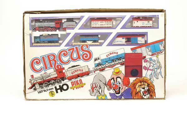 Piko 5/0765 Circus Train Set: HO Piko 5/0765 Circus Train set consisting of 0-8-0 silver and red Steam Loco with word Circus to tender sides, 5 x Circus Goods Rolling Stock (2 x Flat Truck with Lorry and Trailer, Sliding Door Box