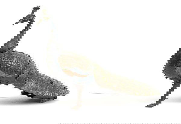 A clockwork Peacock c.1920 by Hans Eberl: A clockwork Peacock c.1920 by Hans Eberl - tinplate bird is blue, green, fitted with clockwork motor and wheels to rear, some overall wear but generally Good Plus fitted with clockwork key.