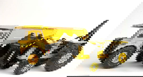 A pair of Tonka Toys Construction Vehicles: A pair of Tonka Toys Construction Vehicles - (1) Tractor with front loader and rear trenching attachment, (2) Heavy Duty Dumper Truck - both are yellow, black, some wear to edges and would benefit fro