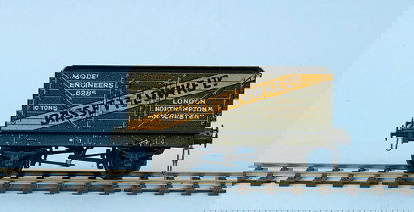Bassett-Lowke O Gauge Private Owner Open Wagon: Bassett-Lowke O Gauge Private Owner Open Wagon finished with a diagonal stripe in yellow with "BASSETT-LOWKE LTD" in black across the wagon. The underneath of the wagon has been adapted to include som