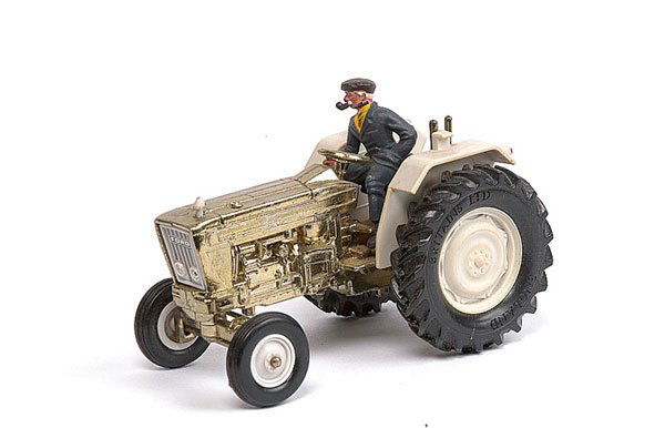 Britains Ford Tractor: Britains Ford Tractor - gold plated Special Edition with cream hubs and trim - complete with figure driver (missing one chimney stack) - unboxed otherwise condition is generally Good Plus - see photo.