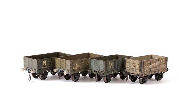 Bassett-Lowke 4-wheeled Tinplate Goods Wagons: Bassett-Lowke 4-wheeled tinplate Goods Wagons consisting of LMS Open Wagon and a NE Open Wagon. The lot also includes a wooden bodied Open Wagon "SCHWEPPS CORDIALS" to wagon sides. Marklin for Bassett