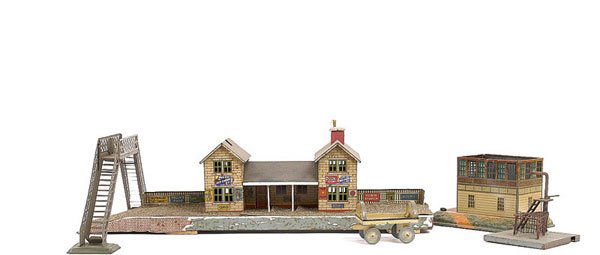 A Group of O Gauge Miscellaneous Items: O Gauge miscellaneous items consisting of a Bing Station measuring 21 1/2" x 5" in length with central double storey building, double track folding footbridge and a Bing signal box, note without roof.