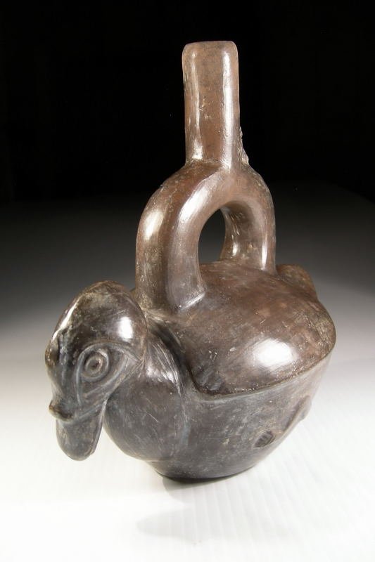 Chimu Blackware Duck: A nicely burnished Chimu duck figure, Ca. 1100 - 1300 A.D. Long billed duck, with beautifully formed head and wings. There is a monkey adorno on the spout. 8-1/2" by 8-1/2". Shipping - $15.00
