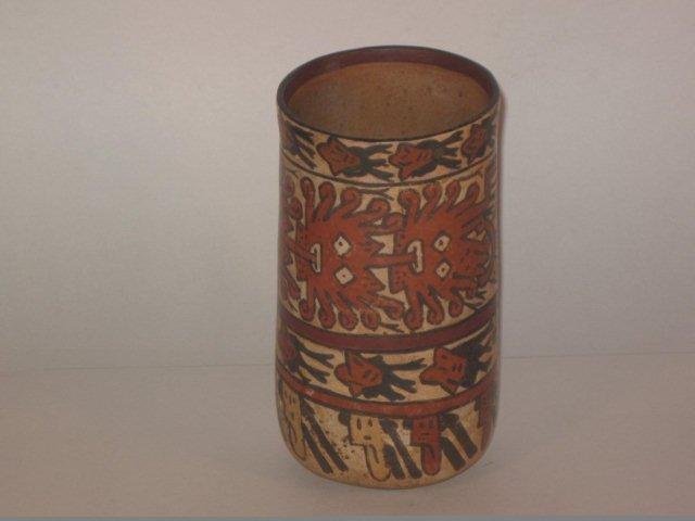 Pre Columbian Nazca Beaker: Nasca tall cylindrical polychrome vessel, Ca. 200 - 600 A.D. 6-1/2" tall by 3-1/4" across. Three registers depicting trophy heads. Large register shows a three headed mythological being with lower bod