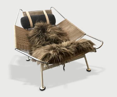 Hans Wegner Flag Halyard Chair: Lounge chair of stainless steel with white paint, rope and sheepskin._x000D_ _x000D_ Manufactured by PP Mobler.