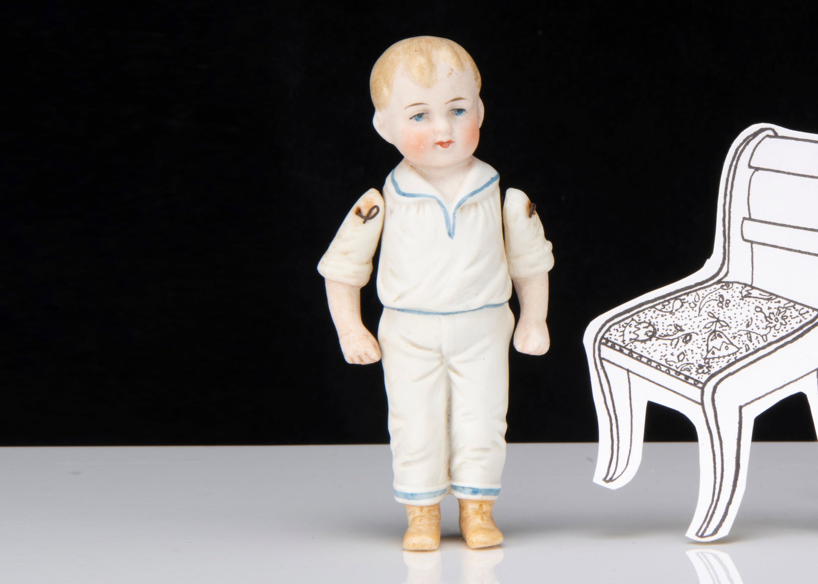 A Limbach all-bisque dolls’ house boy doll,: A Limbach all-bisque dolls’ house boy doll, with blue painted eyes, blonde painted and moulded hair, moulded white suits with blue detail, pin jointed arms and light brown boots, back impressed P.20