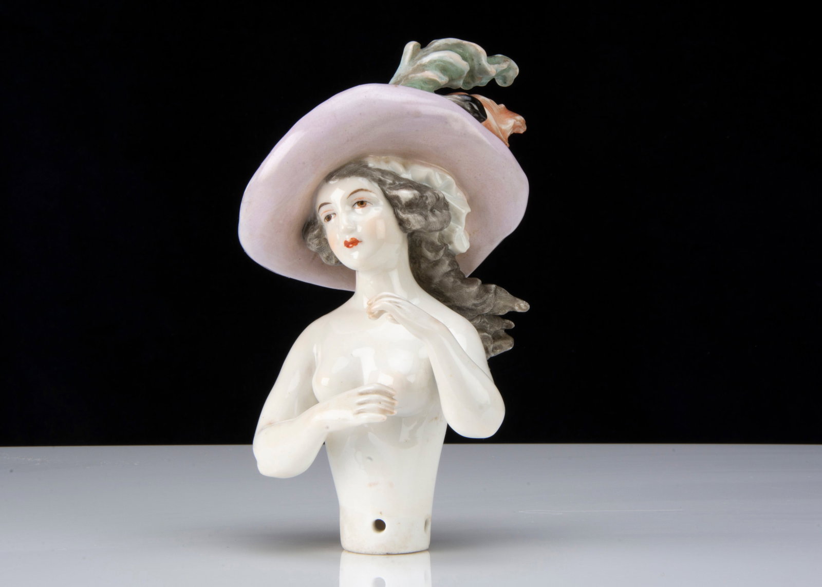 A fine half-doll in elaborate hat, (1 of 2)