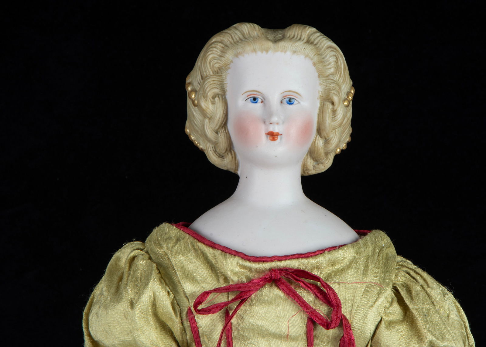 A German bisque shoulder-head doll with elaborate hair, (1 of 3)