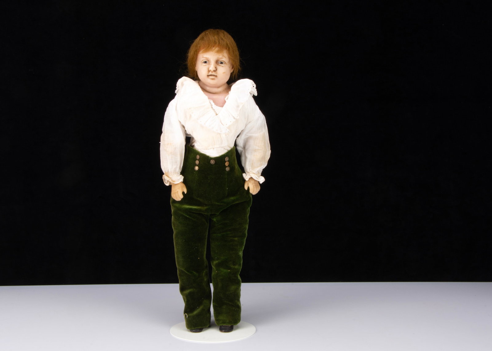 An unusual mid 19th century English poured wax boy doll,: An unusual mid 19th century English poured wax boy doll, with inserted dark glass eyes, eyelid crease, open/closed mouth with moulded top teeth, ears, auburn mohair wig, fat roll at back of neck, arm 