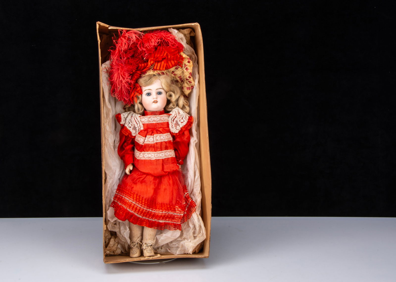 A German 457 bisque head doll in factory dress and box base, (1 of 3)