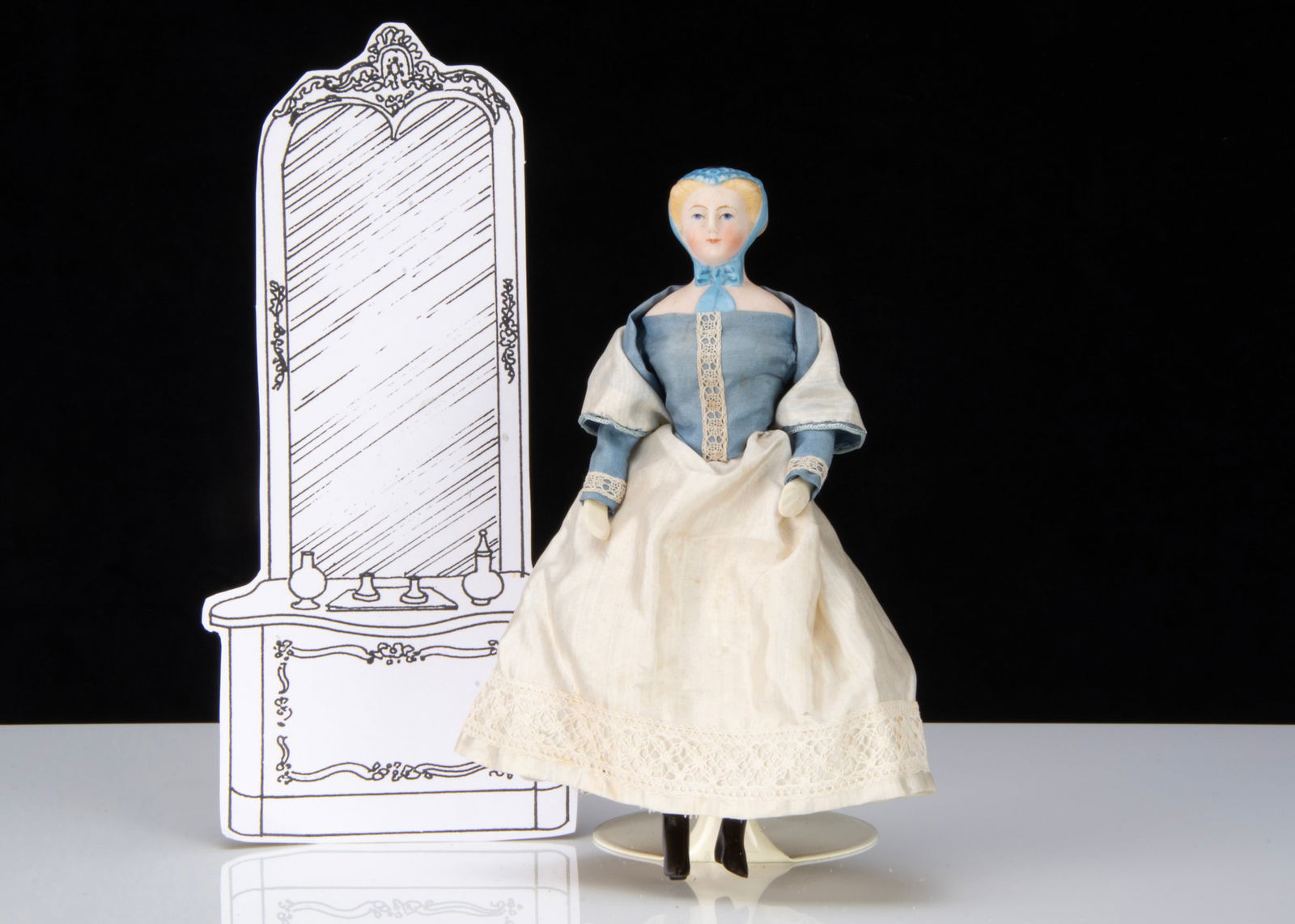 An unusual small or dolls’ house bisque shoulder head doll with moulded cap,: An unusual small or dolls’ house bisque shoulder head doll with moulded cap, with blue painted eyes, blonde painted and moulded hair held in large bun, a blue, black and lace moulded cap with la