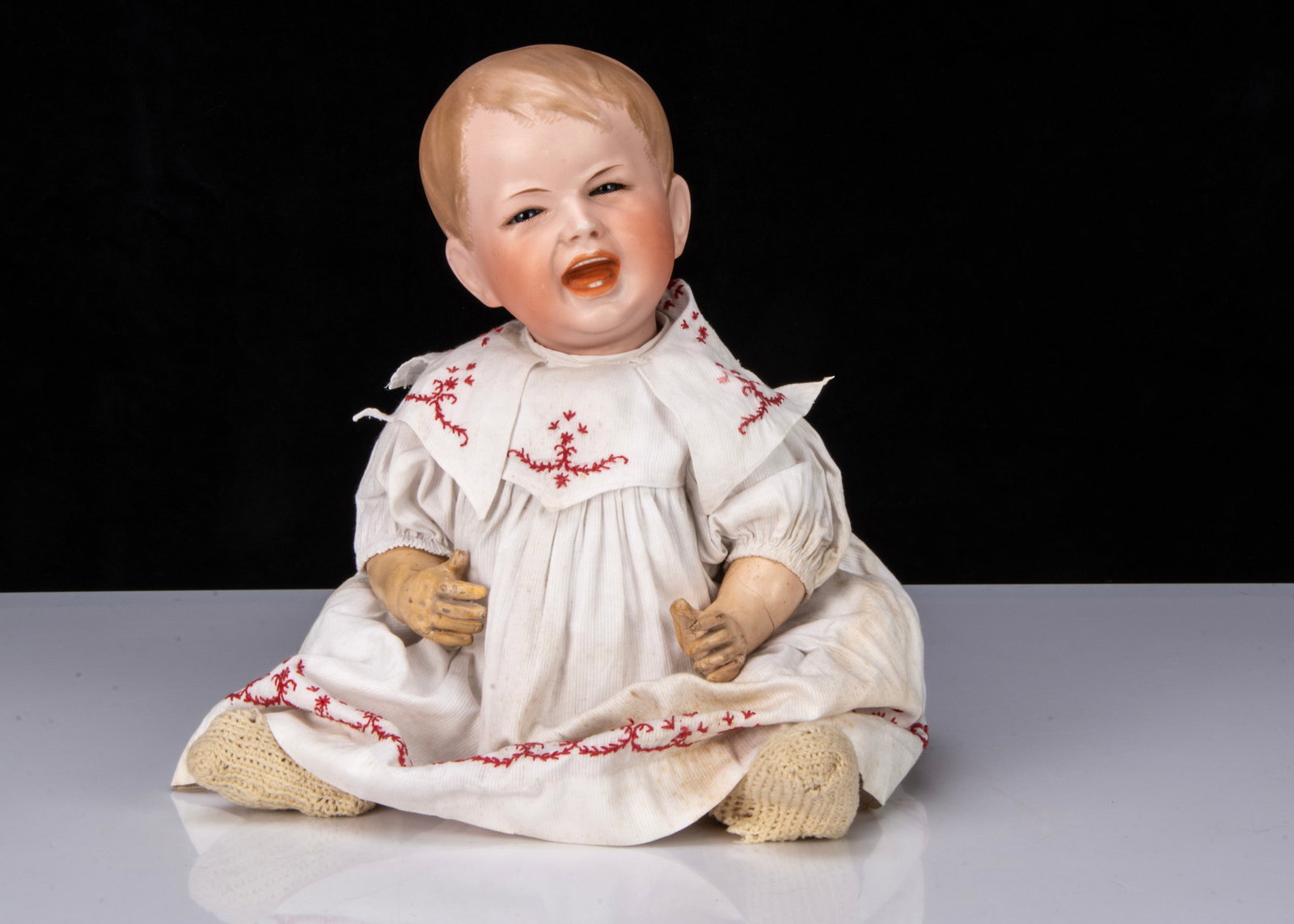 A rare S.F.B.J. 233 crying character baby,: A rare S.F.B.J. 233 crying character baby, with blue glass eyes, creased face, wide open/closed crying mouth with tongue and teeth, blonde painted and moulded hair, bent-limbed papier-mâché 