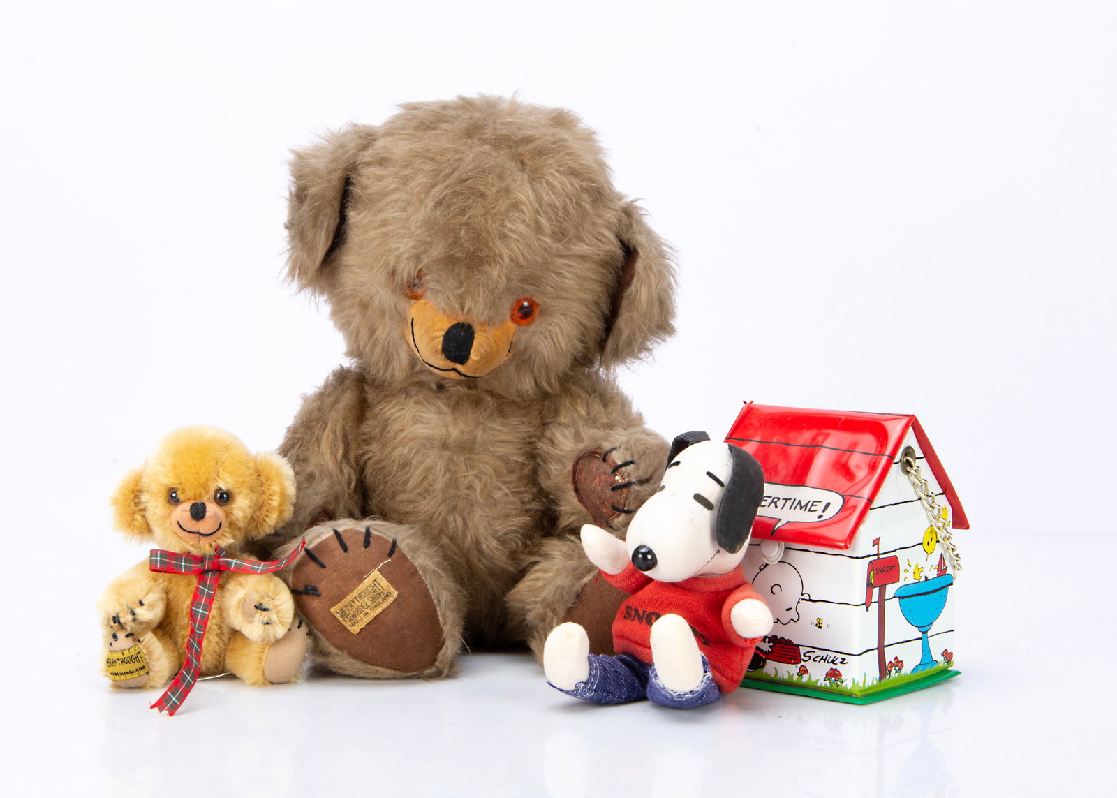 Two Merrythought Cheeky teddy bears,: Two Merrythought Cheeky teddy bears, the larger with brown synthetic plush, orange and black plastic eyes, black stitched nose mouth and claws label to foot pad ó15 ?in. (39.5cm) high; and a vintage 