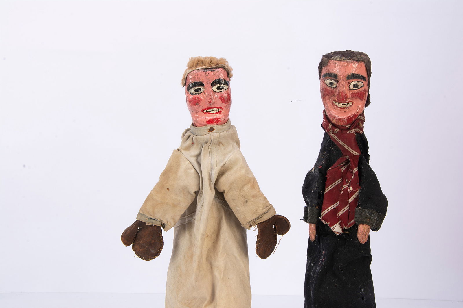 Two professional Punch & Judy puppets from the Vic Taylor and Billy Norman collection,: Two professional Punch & Judy puppets from the Vic Taylor and Billy Norman collection, with simpler carved and painted wooden heads, one a boxer with leather gloves and hangman wearing school tie, bot