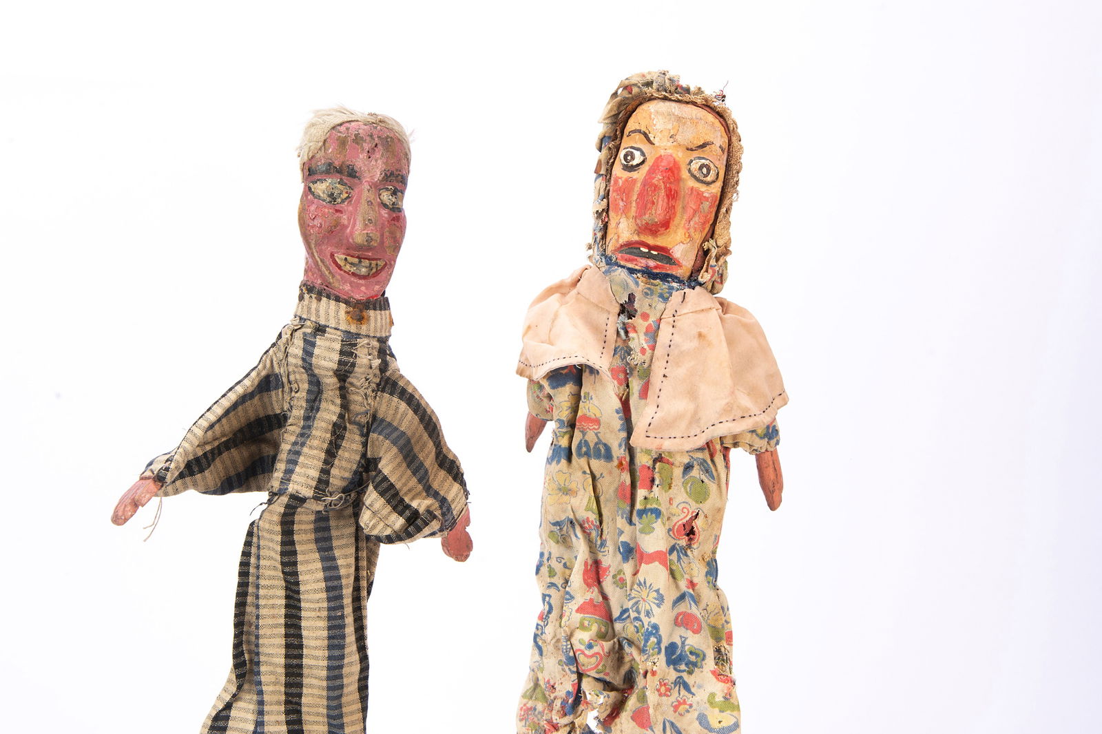 Two professional Punch & Judy puppets from the Vic Taylor and Billy Norman collection,: Two professional Punch & Judy puppets from the Vic Taylor and Billy Norman collection, with simpler carved and painted wooden heads, one Judy with large nose and printed pattern body with wood hands &
