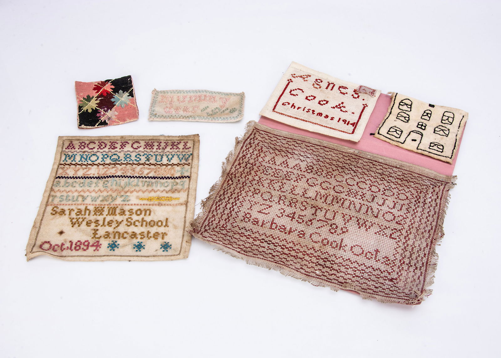 Various school samplers,: Various school samplers, an 1894 wool alphabet by Sarah Mason, Wesley School, Lancaster ó7 Ωin. (19cm.) wide; a red stitched alphabet by Barbara Cook, another embroidered ëMummy Dear 19