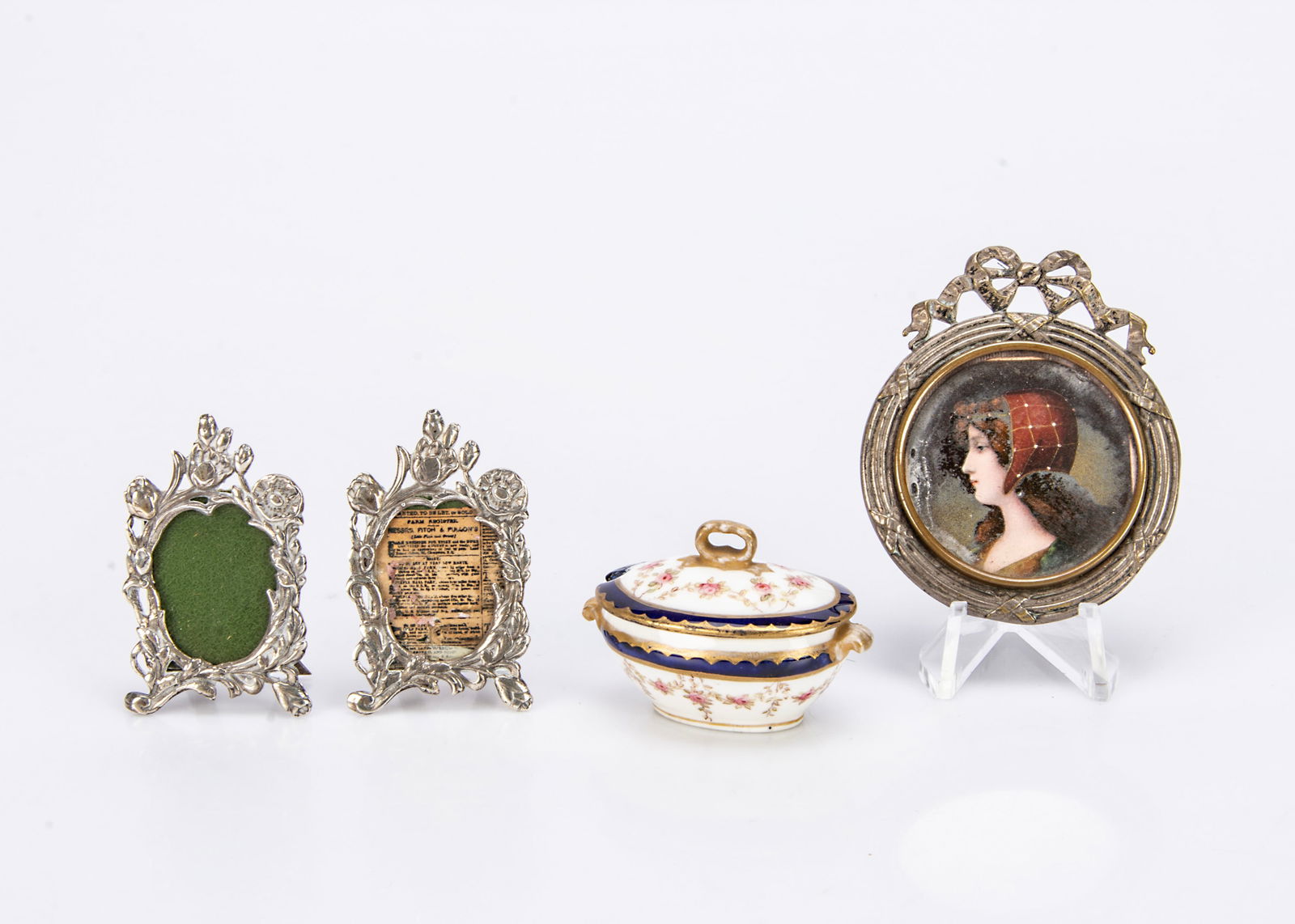 A pair of miniature hallmarked silver picture frames,: A pair of miniature hallmarked silver picture frames, with hinged stands and London date letter for 1979 ó2in. (5cm.) high; a Coaport miniature tureen and cover (neatly restored corner of lid); a