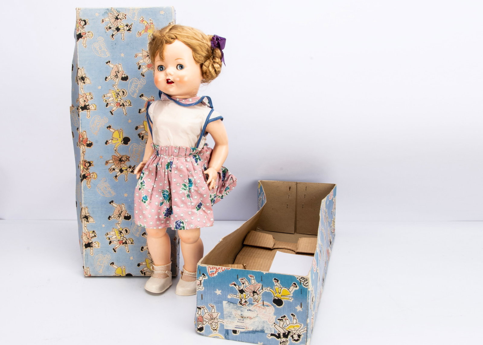 A Pedigree hard plastic Walking Doll,: A Pedigree hard plastic Walking Doll, with blonde hair, original dress and in original box ó21 Ωin. (54.5cm.) high