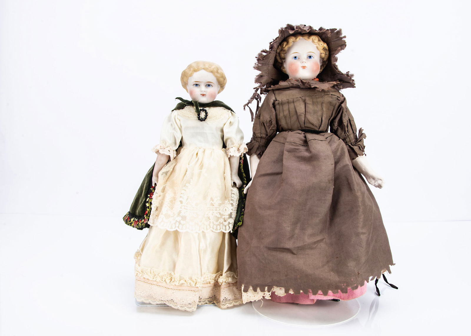 Two late 19th century bisque shoulder-head dolls,: Two late 19th century bisque shoulder-head dolls, probably by Alt, Beck & Gottschalck with blue painted eyes, blonde painted and moulded curly har, stuffed body, the larger with composition arms and b