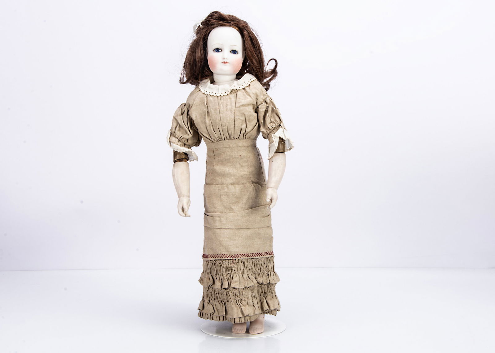 A rare French pressed bisque swivel head fashionable doll,: A rare French pressed bisque swivel head fashionable doll, with deep blue striated glass eyes, black eyeliner, light brown brows, full face, closed pink mouth with protruding top lip and darker pink d