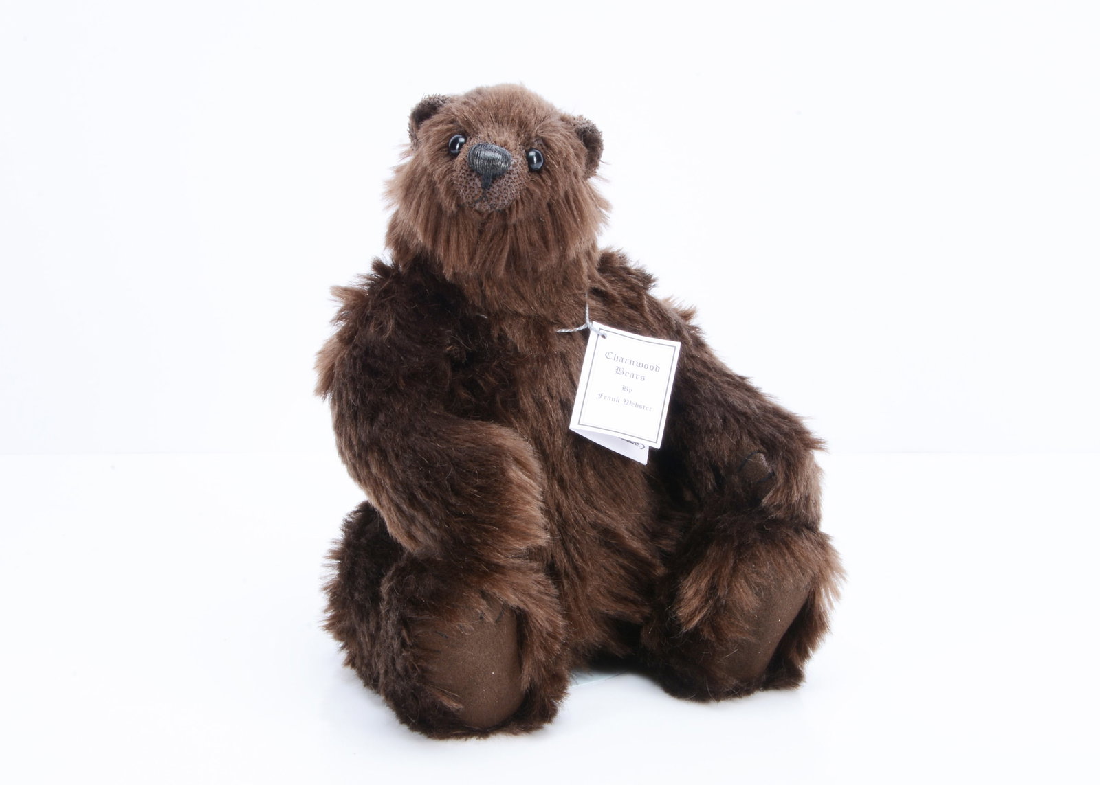 A Charnwood Bears Basu teddy bear by Frank Webster,: A Charnwood Bears Basu teddy bear by Frank Webster, 1 of 1 with brown mohair, black plastic eyes, swivel head and jointed limbs, with card certificate —11 ½in. (29cm.)
