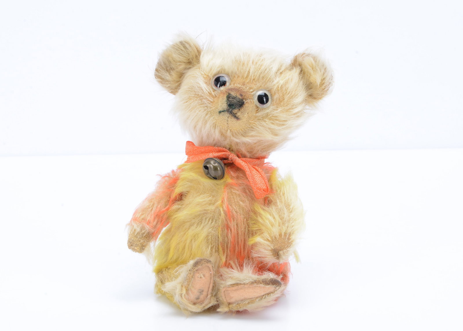 A rare 1920s Jopi clown teddy bear,: A rare 1920s Jopi clown teddy bear, with blonde mohair head and feet, bright orange and yellow frosted mohair arms and body, clear and black glass eyes with remains of painted backs, black stitched no