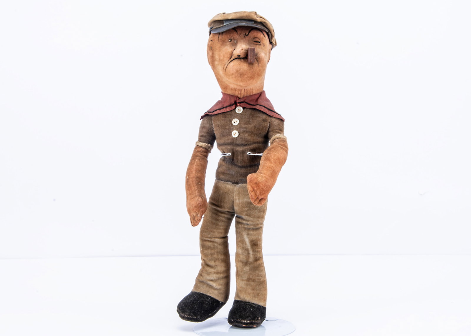 A Dean’s Rag Book Co Popeye the Sailor, circa 1936,: A Dean’s Rag Book Co Popeye the Sailor, circa 1936, with pink velvet head and ears, integral blue sailor’s suit, cap with ‘Popeye’ label, wooden pipe and blue and white printed