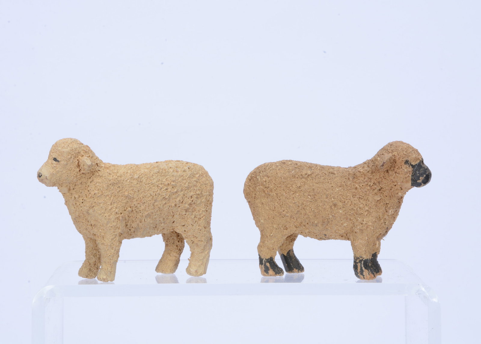 Two Forest Toys of Brockenhurst sheep,: Two Forest Toys of Brockenhurst sheep, carved and painted wood, textured finish, one with black face —3in. (7.5cm.) long (a little discoloured)