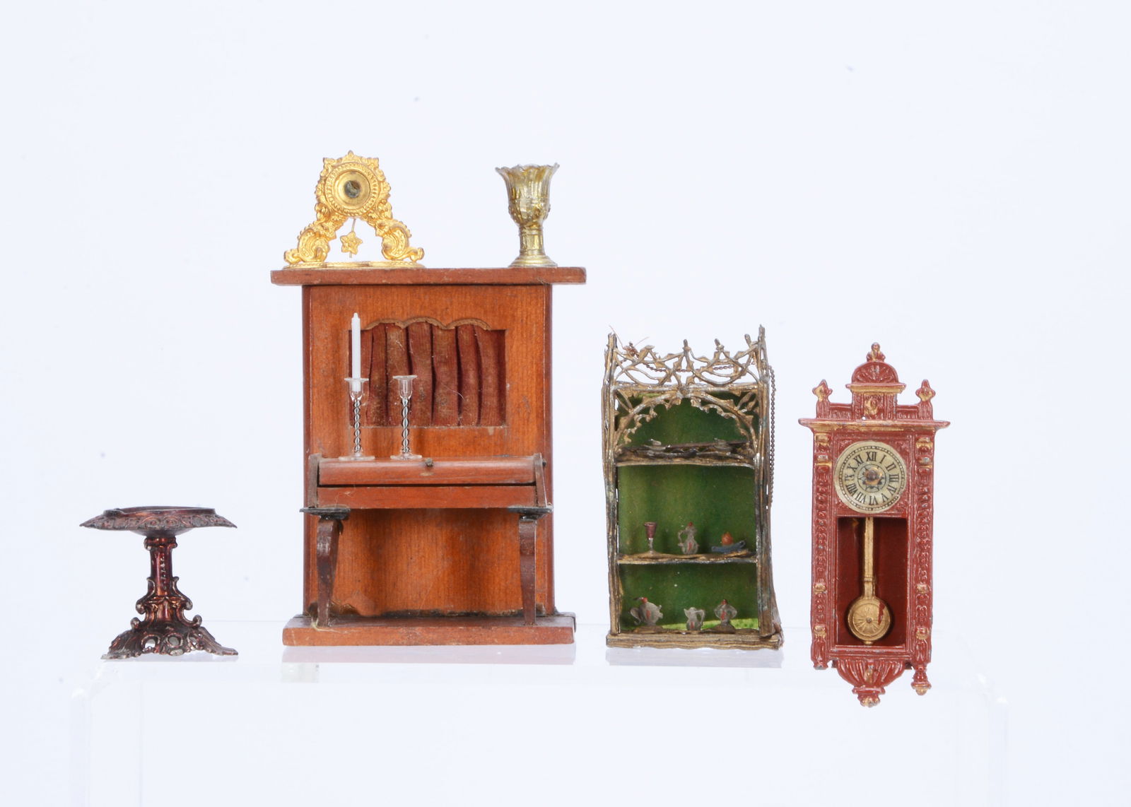 Dolls’ house chattels and a Wallclimber piano,: Dolls’ house chattels and a Wallclimber piano, the red stained piano with lifting lid, cabriole legs and curtained strings —3 ¾in. (9.5cm.) high; a cast-metal mahogany painted wall cl