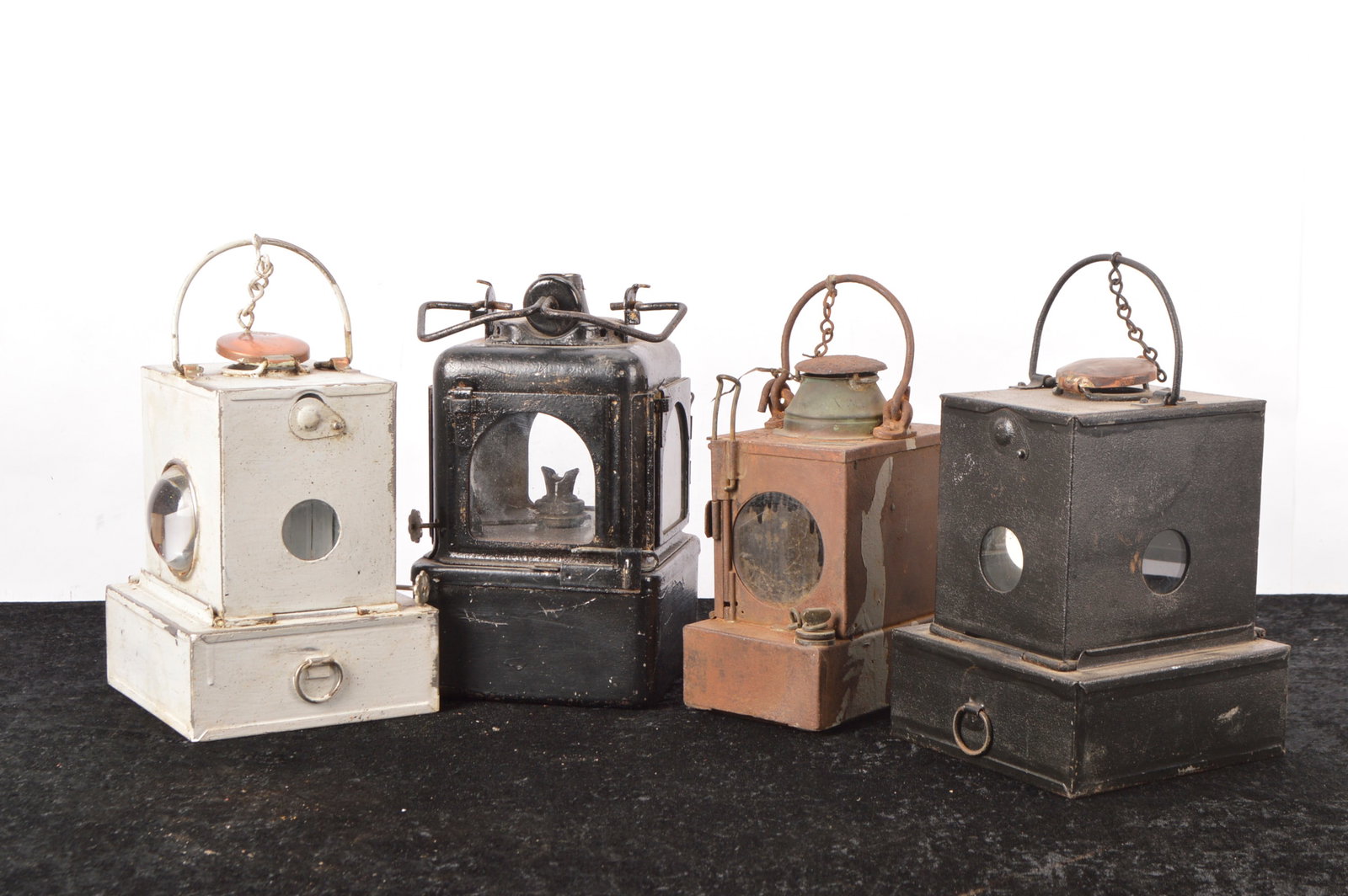 Railway Inner lanterns (4): Railway Inner lanterns (4) all of square/rectangular form some repainted, all with loop handles, the tallest 30cm high, BR (M) Welch Patent with undamaged lenses and burner present, SR/ SER, corroded