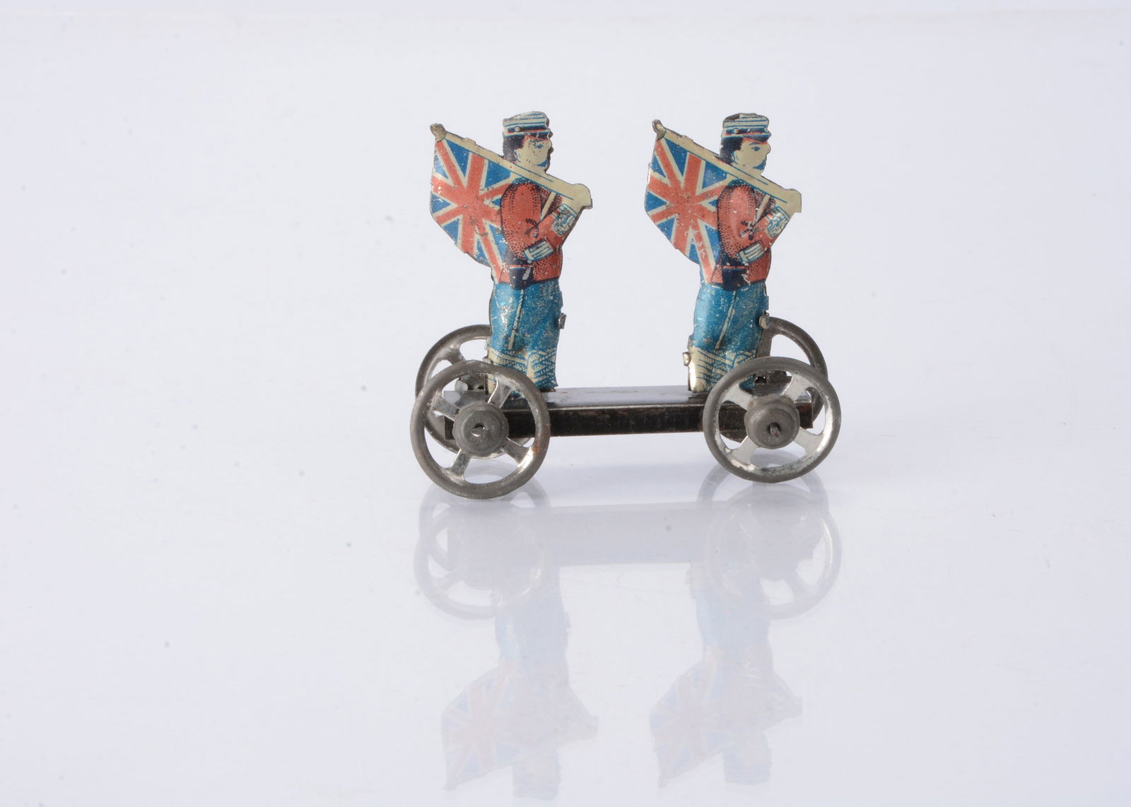 A Japanese Penny Toy of two English soldiers carrying Union flags, (1 of 2)