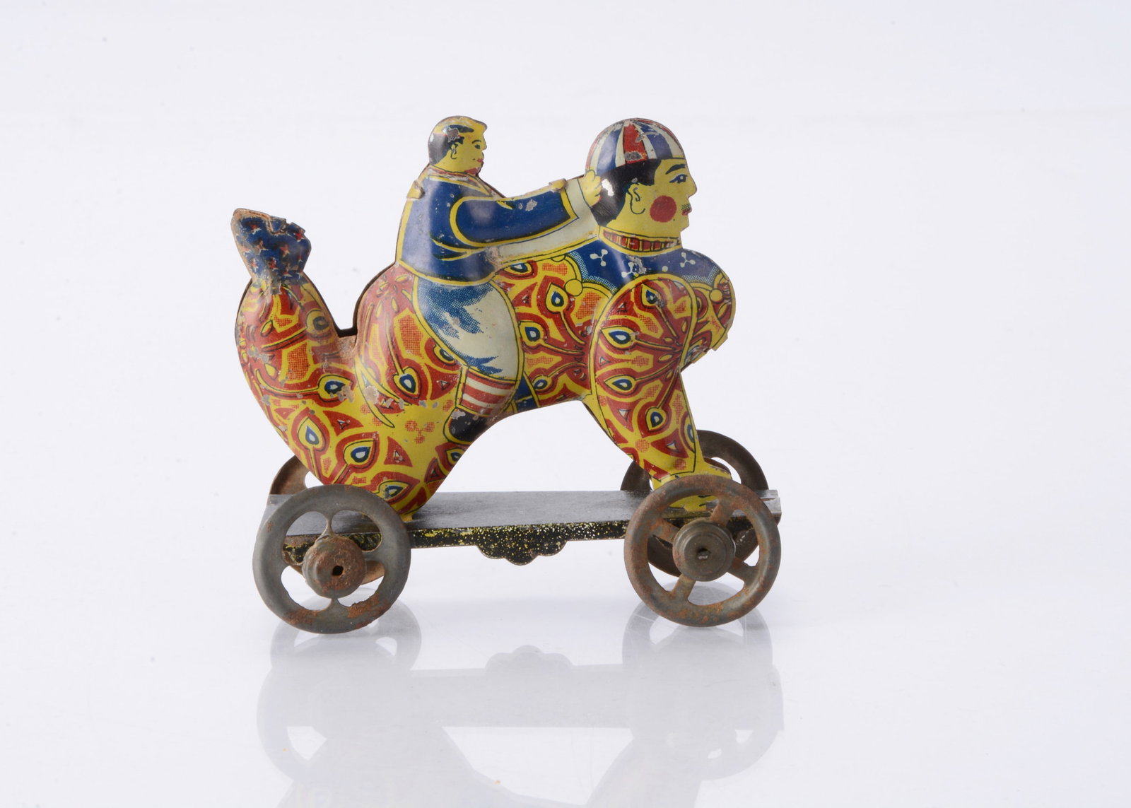 A Japanese Penny Toy of a boy riding a clown, (1 of 2)