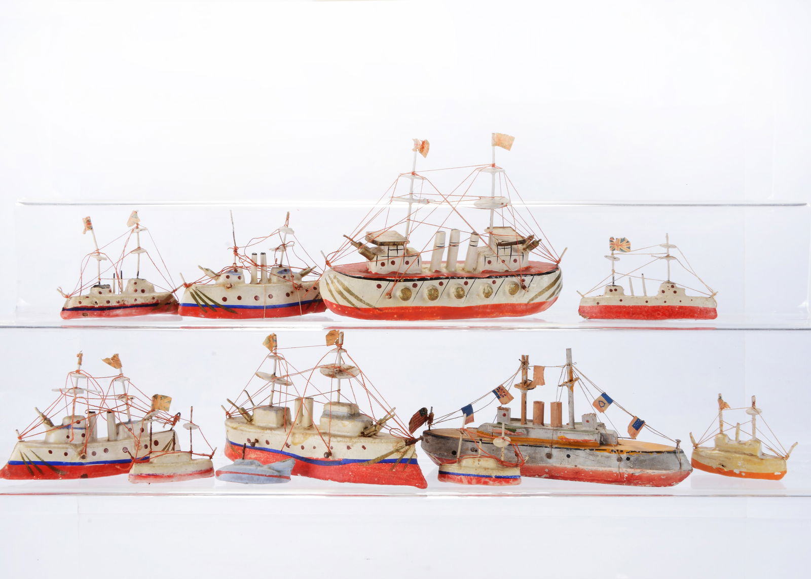 A group of Japanese wood and composition battleships,: A group of Japanese wood and composition battleships, mainly painted white and red, paper flags for Britains and USA —6in. (15.5cm.) longest (slight wear)