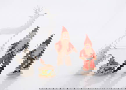 Christmas items,: Christmas items, a Lauscha milk glass stag —4 ¾in. (12cm.) high, two composition faced Father Christmases, a bisque snowed Father Christmas candle holder and a gnome candy box