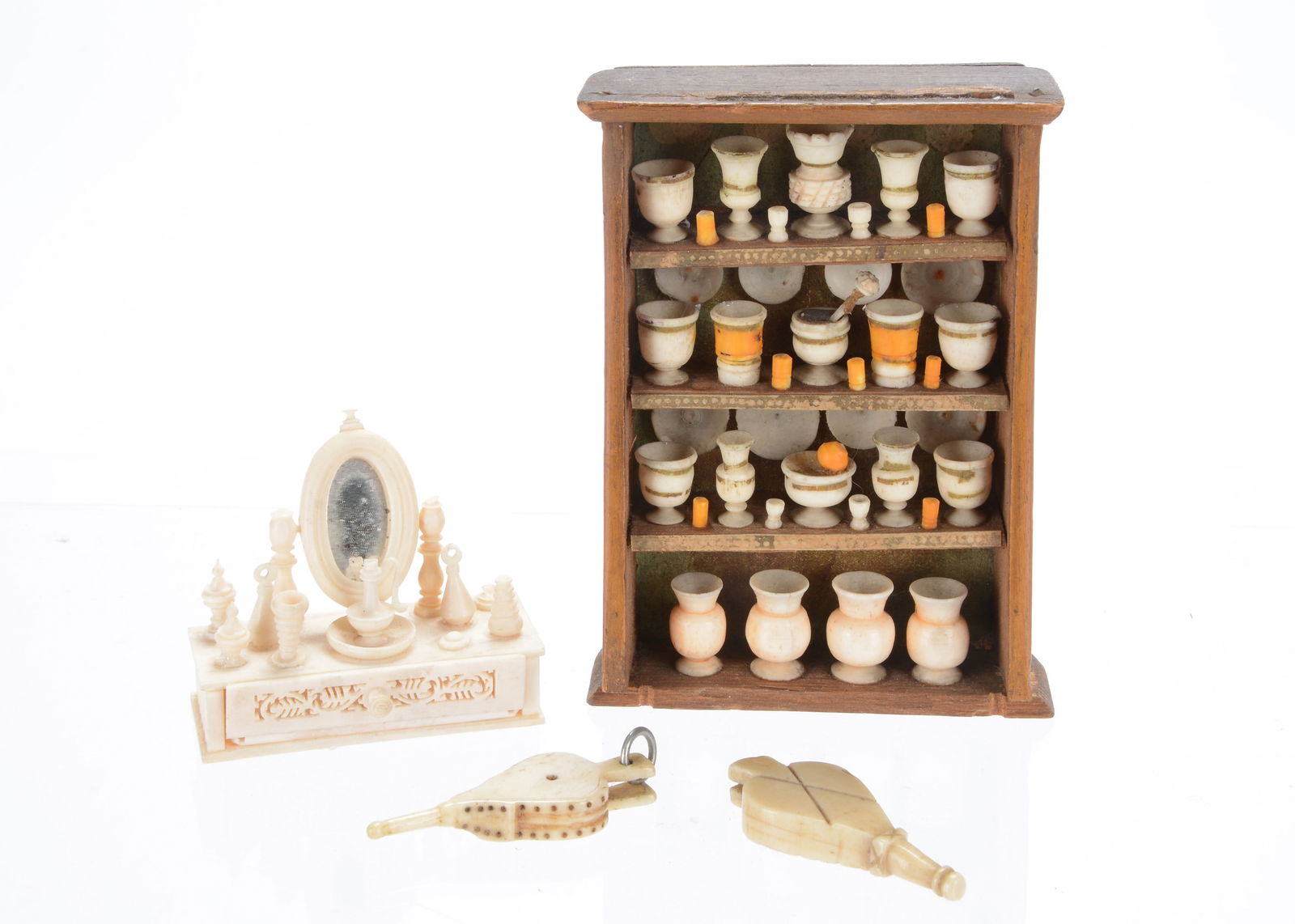 19th century bone dolls’ house items,: 19th century bone dolls’ house items, a wooden shelf with four rows of bone vessels, possibly an apothecary cabinet —4in. (10cm.) high (some parts of cabinet damaged or missing), a dressin