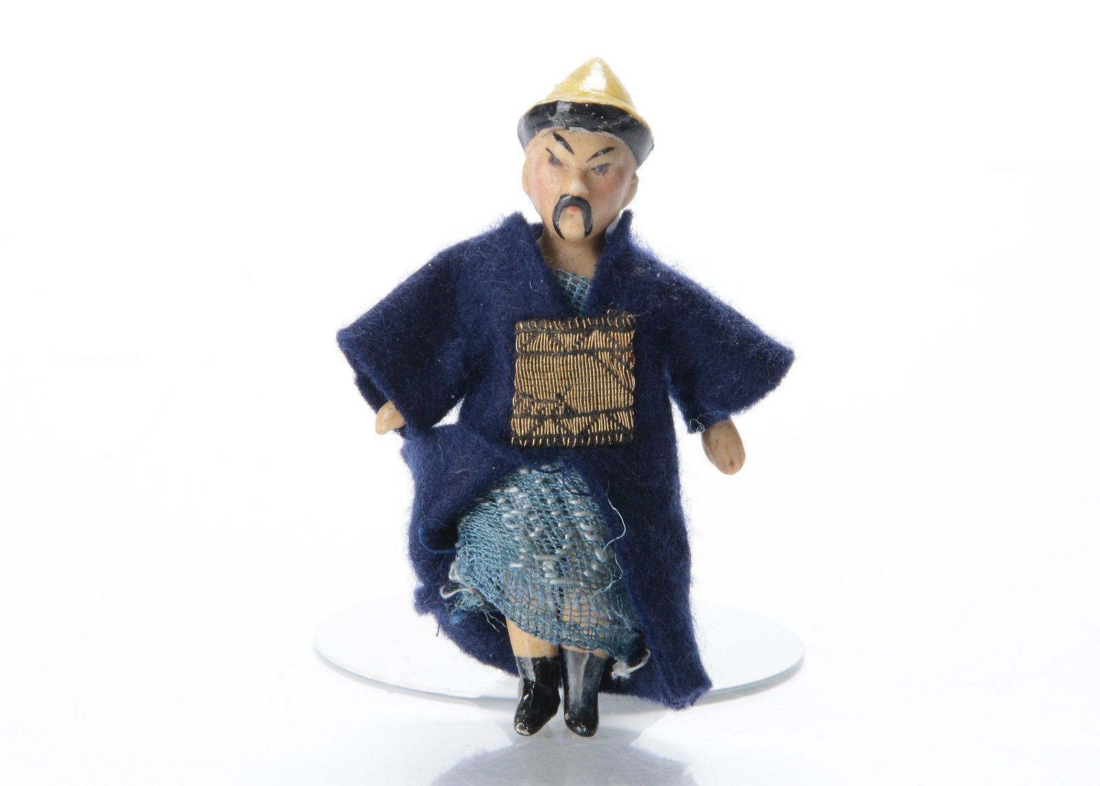 A German all-bisque dolls’ house china man doll,: A German all-bisque dolls’ house china man doll, with brown painted slanted eyes, black painted and moulded long moustache, moulded yellow and black pointed hat, jointed at shoulders and hips an