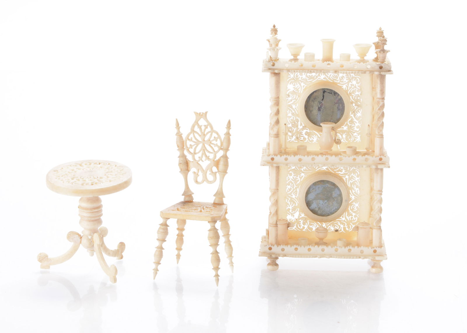 A19th century bone dolls’ houses what-not,: A19th century bone dolls’ houses what-not, with circular mirror inset on the back and various turned vessels —4in. (10.5cm.) high, a similar chair and occasional table (each with a glued l