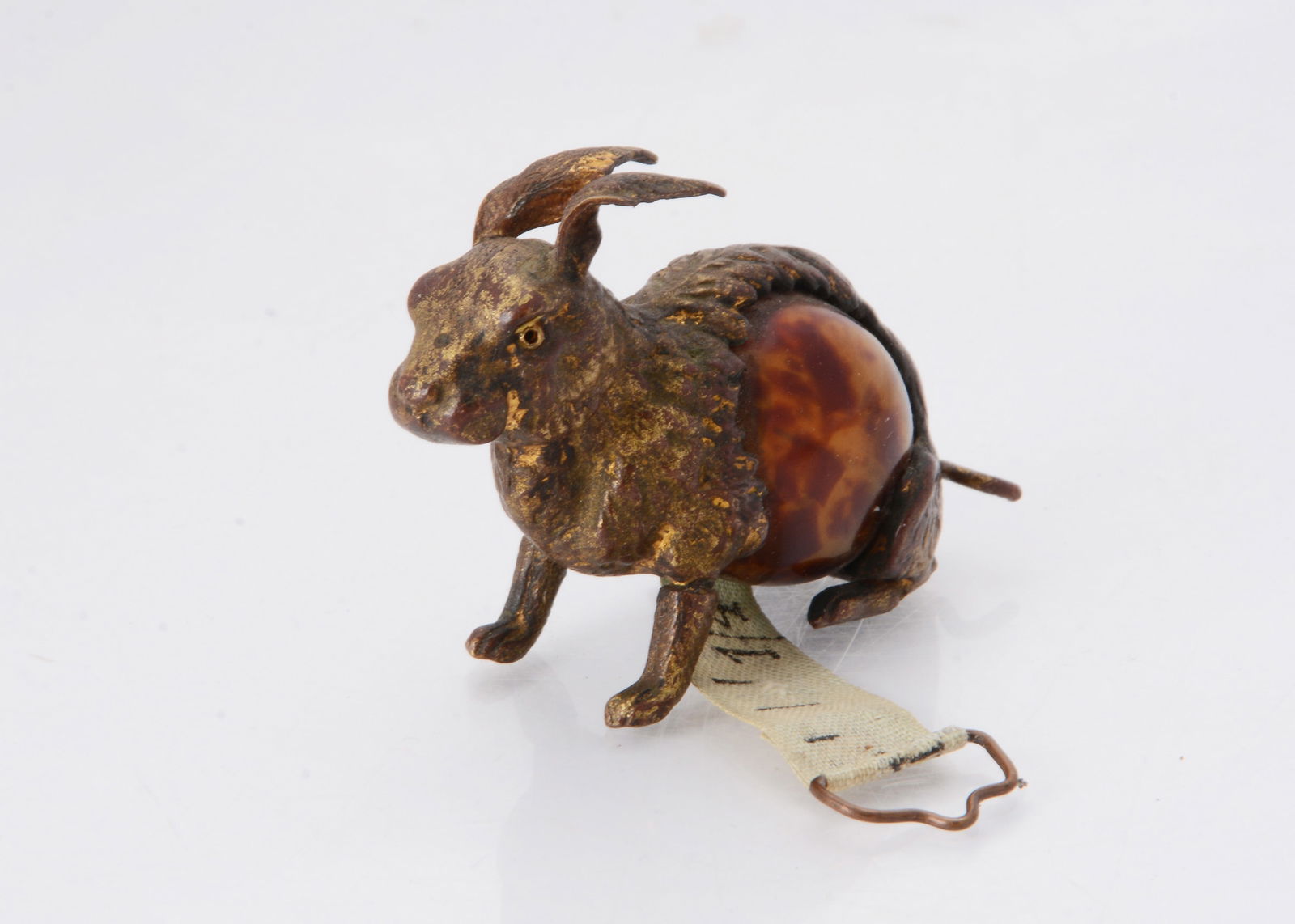 An early 20th century brass and faux tortoiseshell rabbit tape measure, (1 of 1)