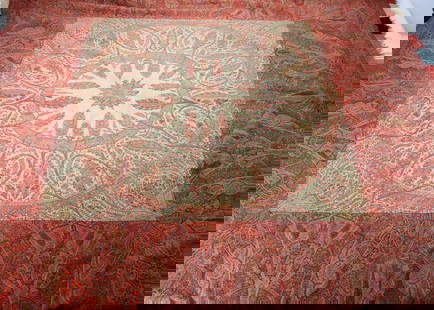 A 19th century paisley wool shawl,: A 19th century paisley wool shawl, square with white ground centre, worked with tree pattern in multicolours with border, made in sections —78in. x 73in. (198cm. x 185.5cm.) (small holes)