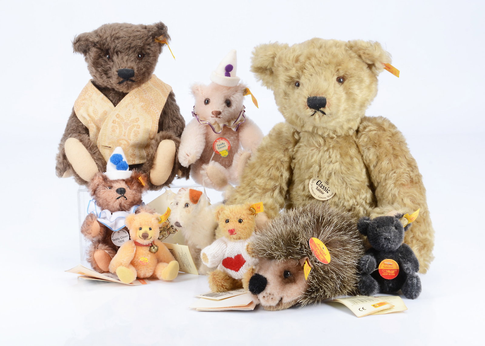Nine Steiff yellow tag teddy bears/ soft toys,: Nine Steiff yellow tag teddy bears/ soft toys, a SteiffClassic 1920 replica with golden mohair --13 1/2in. (34.5cm.) high; a Classic 1920 replica with dark brown mohair, a teddy clown with rosa (pink)
