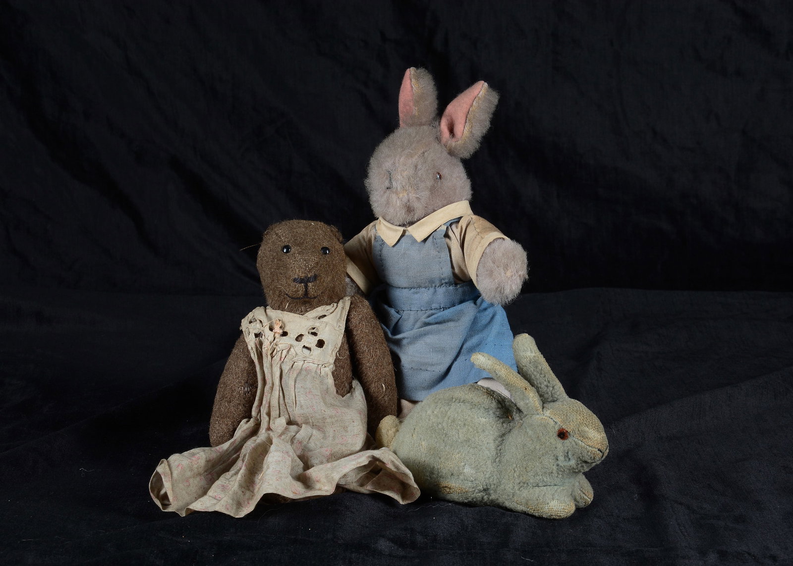 Jennifer Warner’s childhood toys,: Jennifer Warner’s childhood toys, a 1910-20 burlap teddy bear with black pin head eyes, black stitched nose and mouth, slotted-in-ears, unjointed neck, pin-jointed limbs and floral printed white