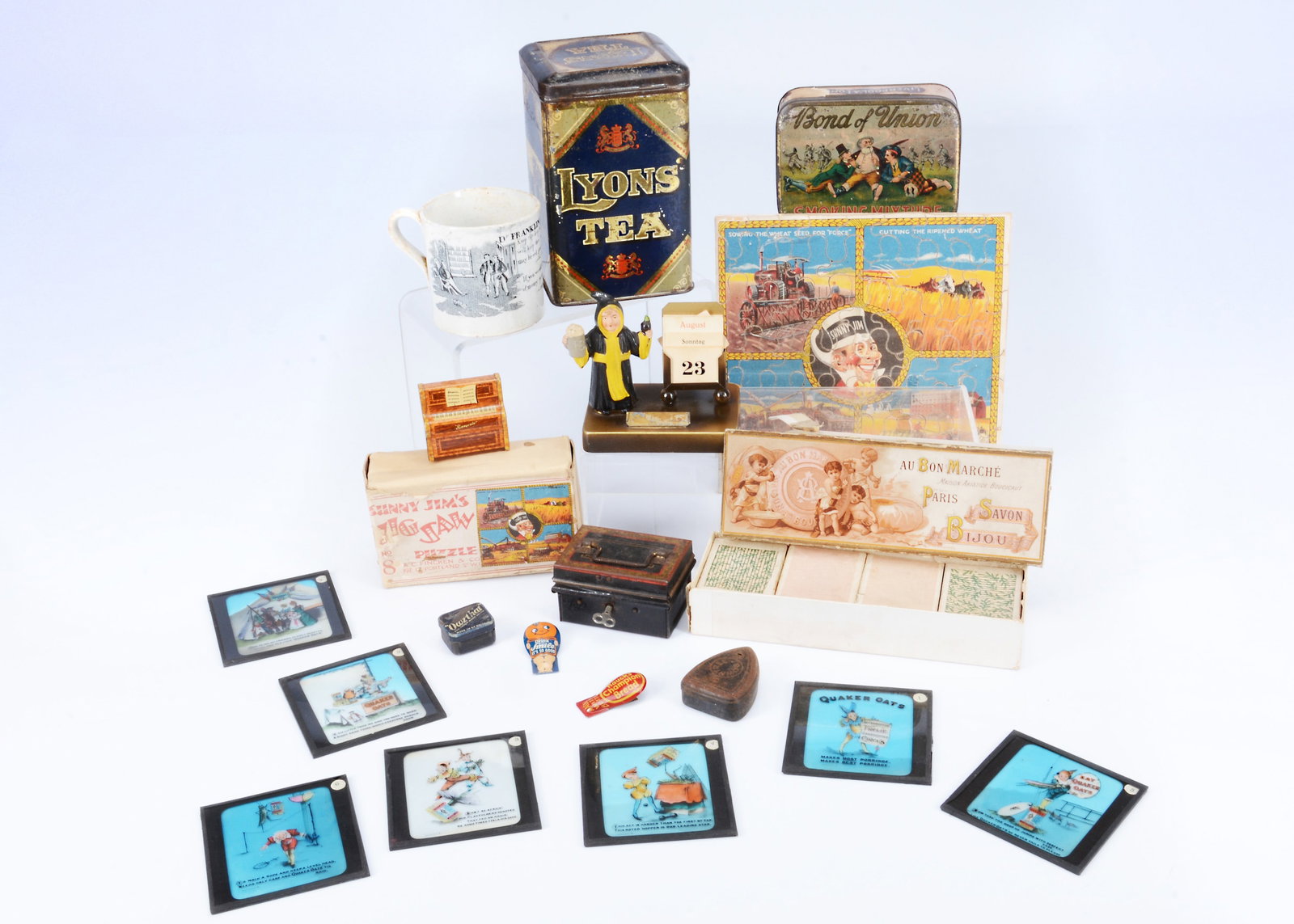 Advertising items,: Advertising items, a Lyons’ Tea canister with image of motor delivery van one side —6 1/2in. (16.5cm.) high, a lead Munich monk beer calendar; seven glass slides of Quaker Oats; a Sunnyval