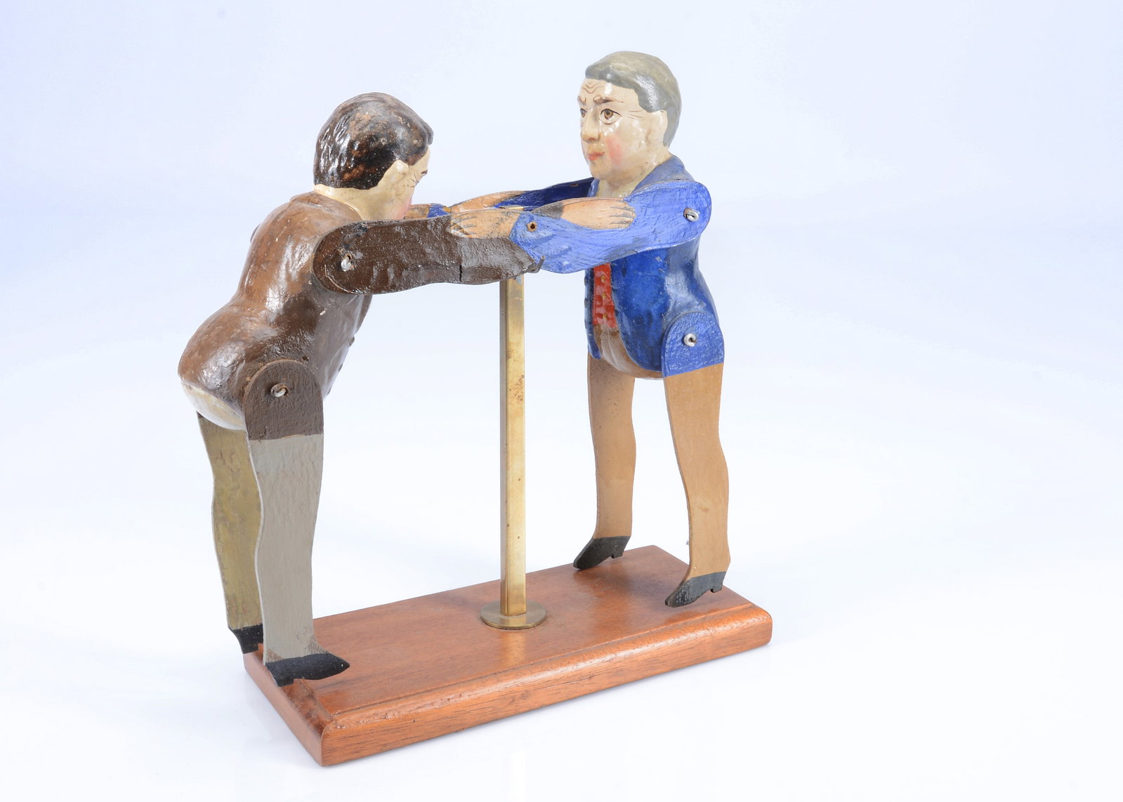 An Albin Amende Sonneberg USA Presidential wresting toy, circa 1912,: An Albin Amende Sonneberg USA Presidential wresting toy, circa 1912, papier-mâché painted figures with jointed wooden limbs the arms attached and printed paper laid on wood and string hole t