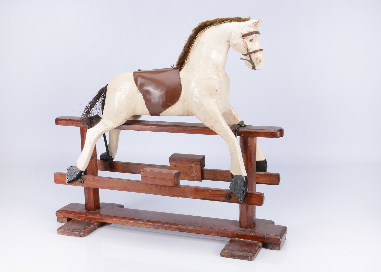 An early 20th century English small carved wooden rocking horse, (1 of 2)