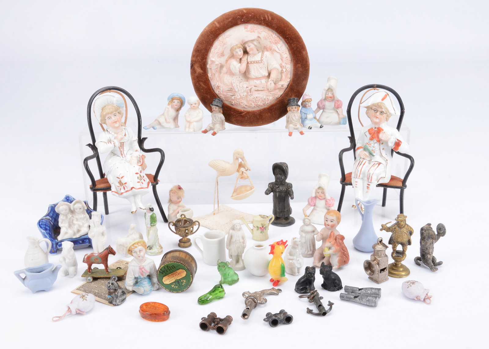 Four whistles and various novelties,: Four whistles and various novelties, French cast-metal whistles in the form of a lantern —1 1/2in. (4cm.) high, a pistol, an anchor and a pair of binoculars; four Czechoslovakian glass animal ch
