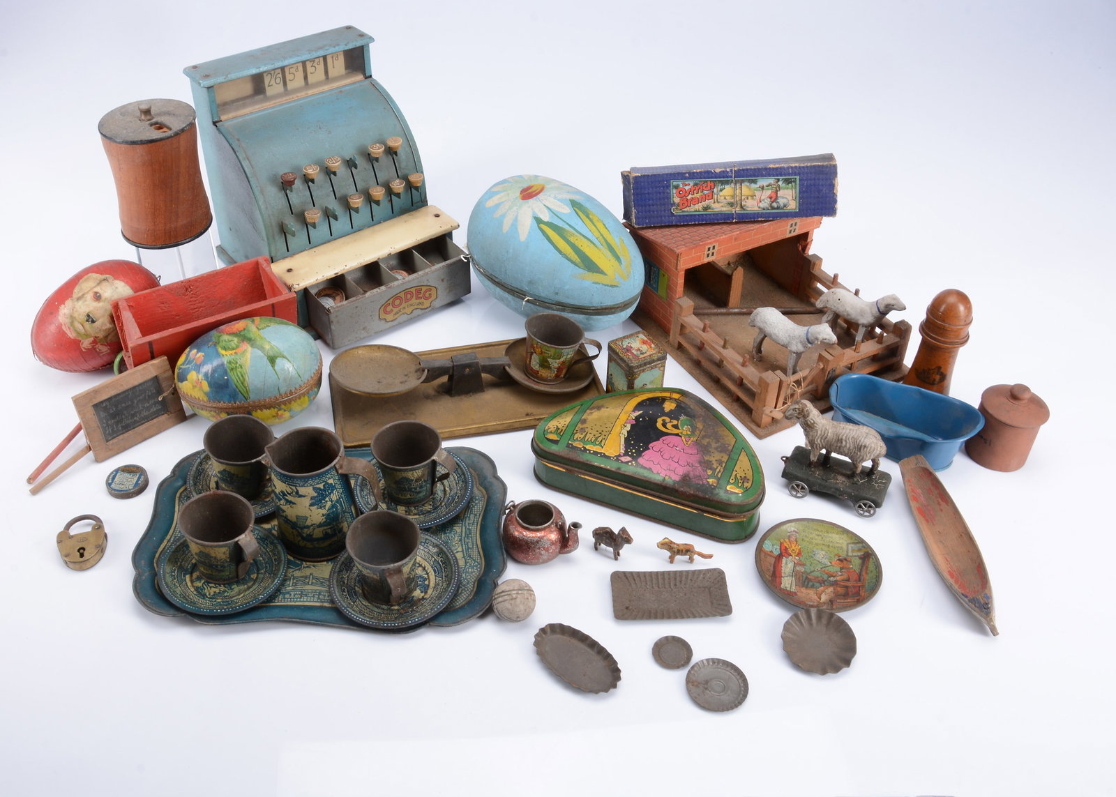 Easter eggs and various toys,: Easter eggs and various toys, three early 20th century card Easter eggs, one painted blue with a flower, the inside lid printed with characters including a teddy bear —7in. (18cm.) high; a small