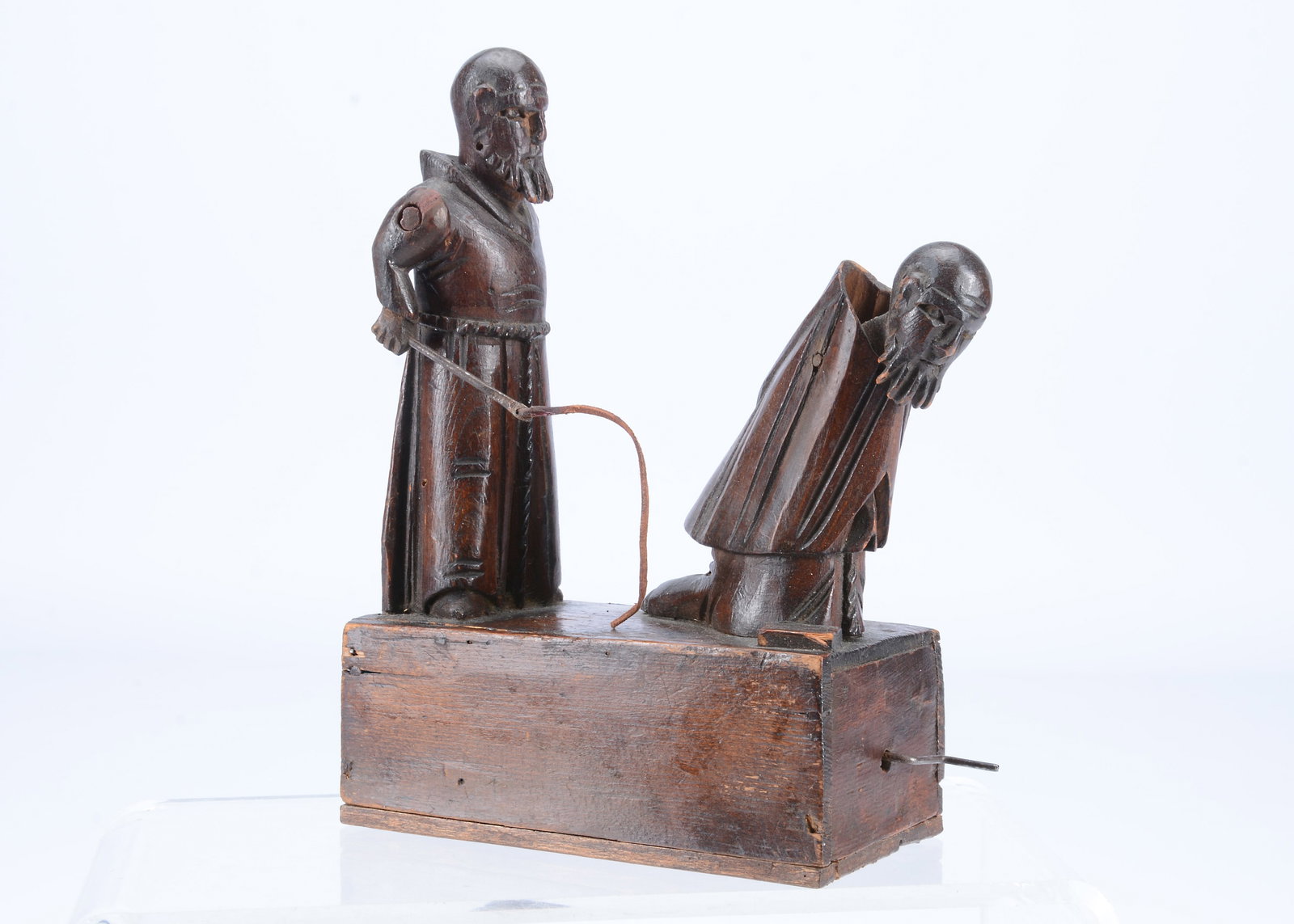 An 19th century Grödnertal carved wooden hand cranked toy of flagellating monks, (1 of 2)